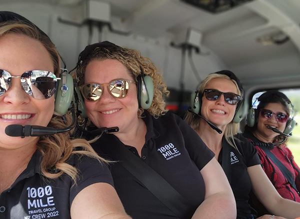 Group of women in a helicopter wearing ear muffs